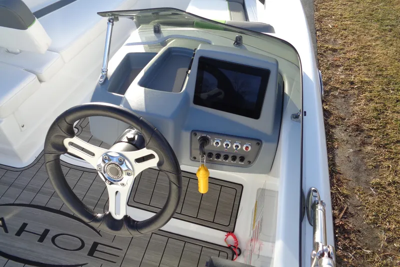 Slide: The Image of 2023 Tahoe T16 boat dashboard with steering wheel and control panel. - 8