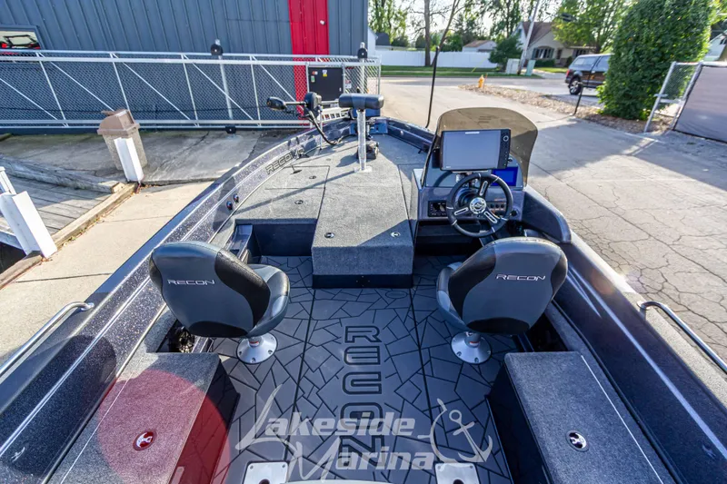Slide: The Image of 2024 Recon 985 SC fishing boat interior with dual seats and advanced navigation system. - 10