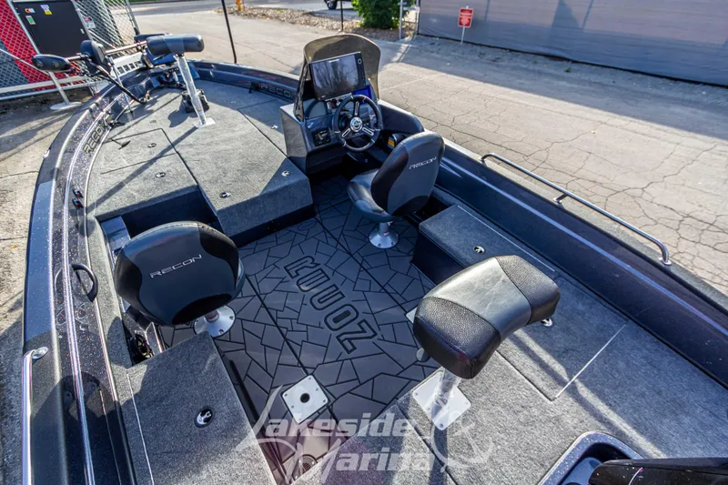 Slide: The Image of 2024 Recon 985 SC fishing boat interior with seating and control console. - 12