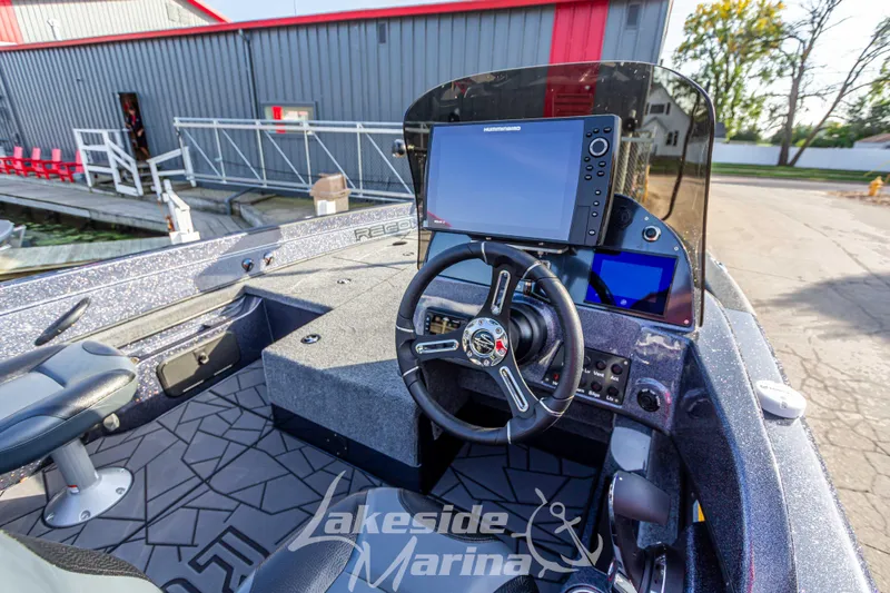 Slide: The Image of 2024 Recon 985 SC boat dashboard at Lakeside Marina. - 16