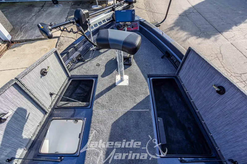 Slide: The Image of 2024 Recon 985 SC fishing boat interior with storage compartments and seating at Lakeside Marina. - 26