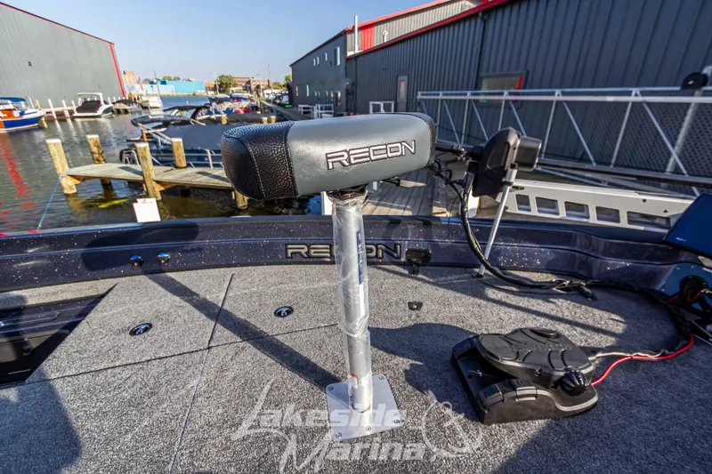 Slide: The Image of 2024 Recon 985 SC boat at marina, featuring advanced fishing equipment. - 29