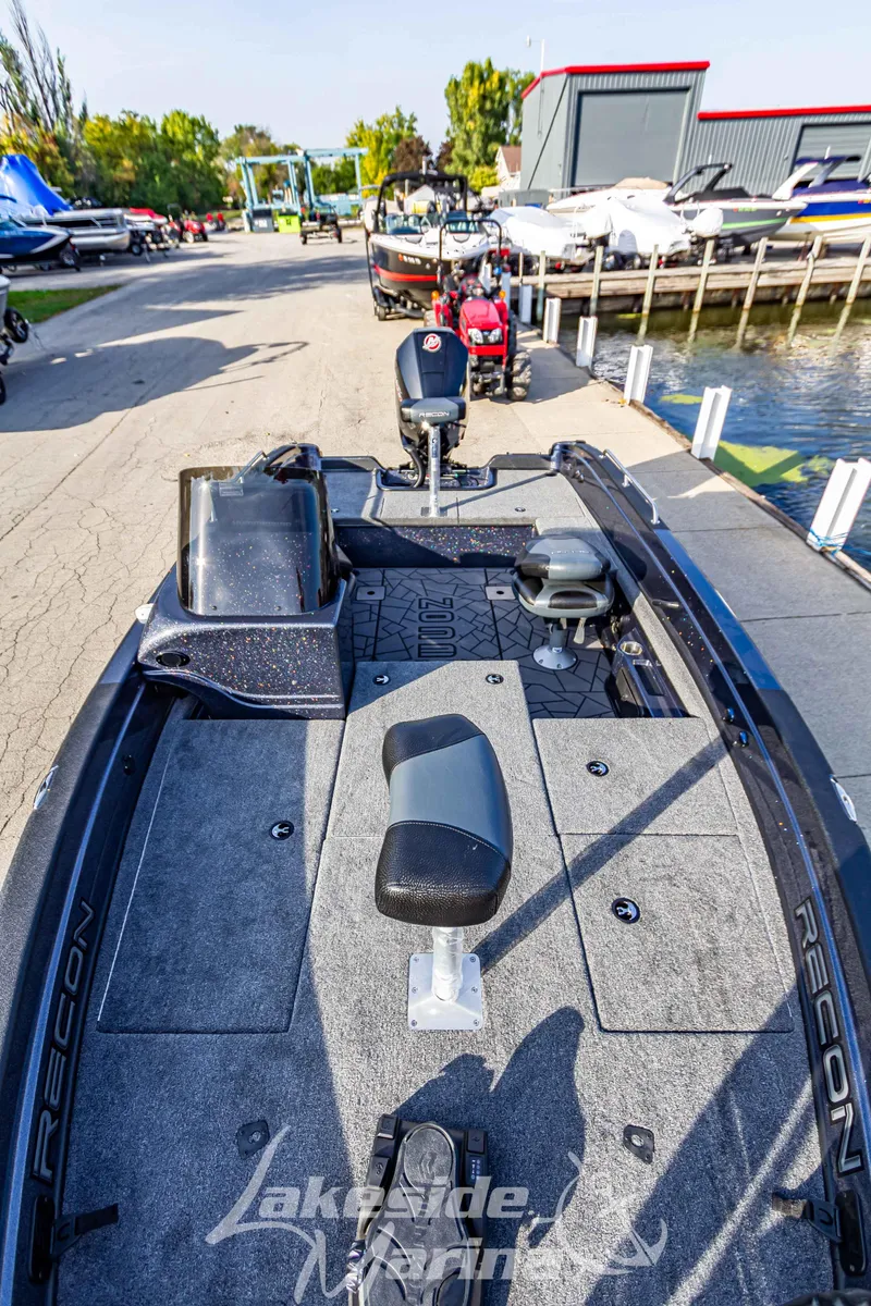 Slide: The Image of 2024 Recon 985 SC fishing boat docked at a marina. - 33