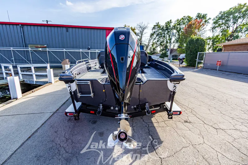 Slide: The Image of 2024 Recon 985 SC boat at dock, rear view with outboard motor. - 5