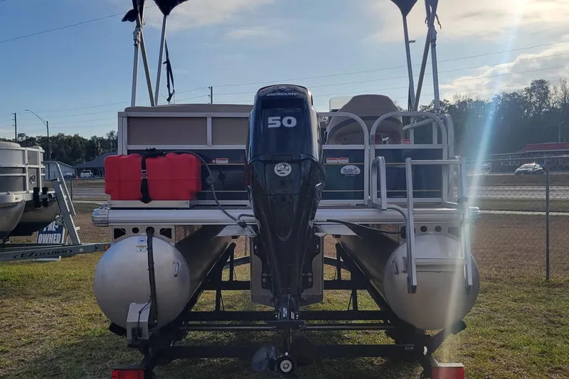 Slide: The Image of 2021 Sun Tracker Bass Buggy 16 XL Select pontoon boat with 50 HP motor, parked outdoors. - 3