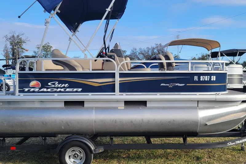 Slide: The Image of 2021 Sun Tracker Bass Buggy 16 XL Select pontoon boat with canopy on trailer. - 4