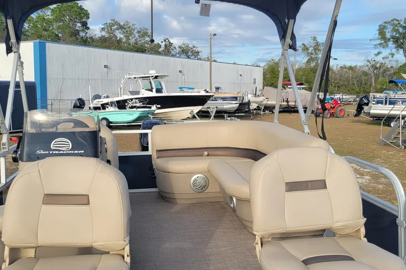Slide: The Image of 2021 Sun Tracker Bass Buggy 16 XL Select pontoon boat with beige seating and canopy. - 5