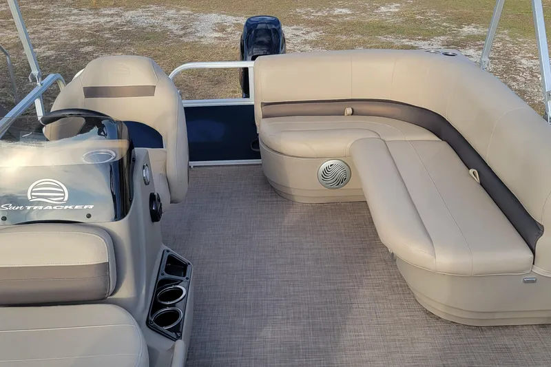 Slide: The Image of 2021 Sun Tracker Bass Buggy 16 XL Select pontoon boat interior with beige seating. - 7