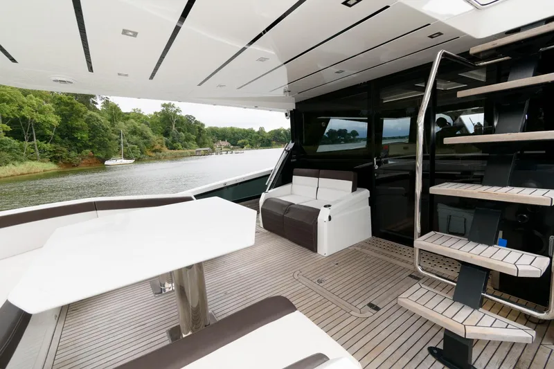 Slide: The Image of 2018 Galeon 640 Fly yacht docked with inflatable boat on stern. - 13