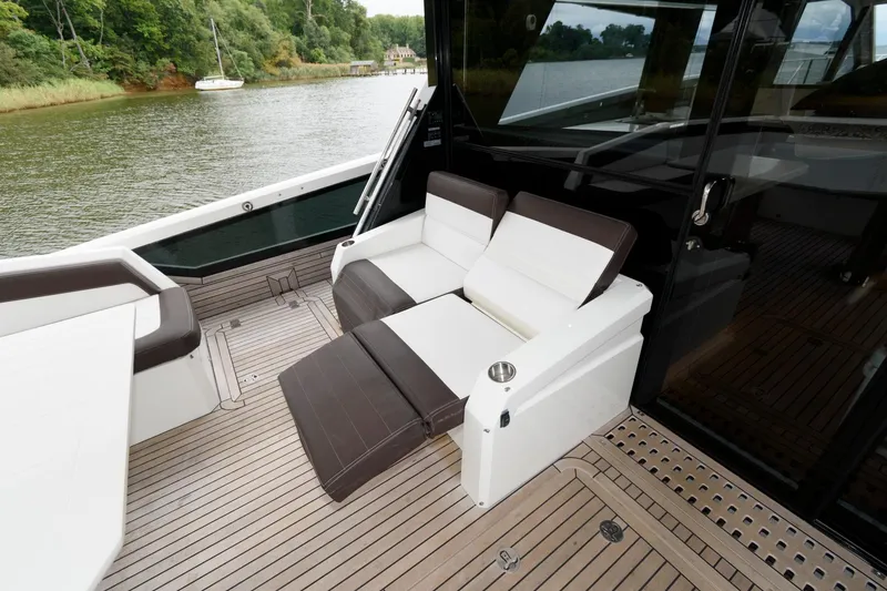 Slide: The Image of 2018 Galeon 640 Fly yacht with spacious deck seating at the marina. - 15