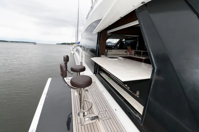 Slide: The Image of Luxurious 2018 Galeon 640 Fly yacht deck with seating and scenic river view. - 17