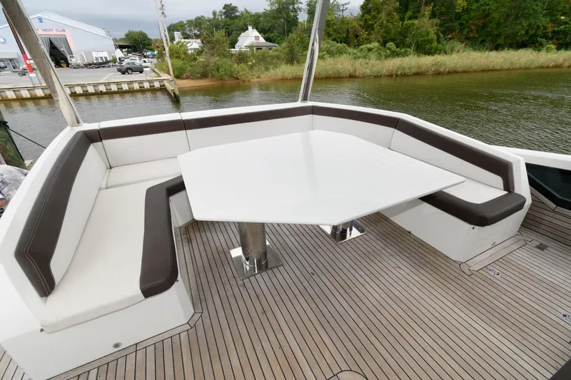 Slide: The Image of Luxurious seating on 2018 Galeon 640 Fly yacht deck, overlooking serene waterway. - 19