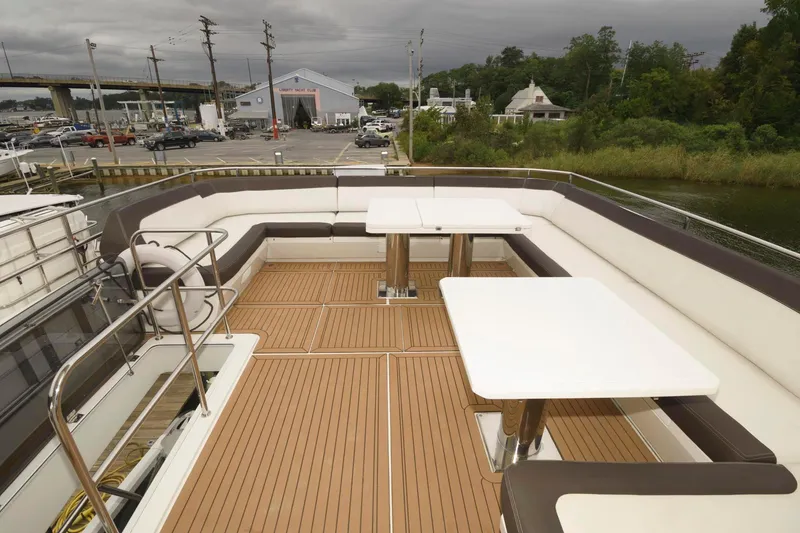 Slide: The Image of 2018 Galeon 640 Fly yacht with open bar area and stools on deck. - 21
