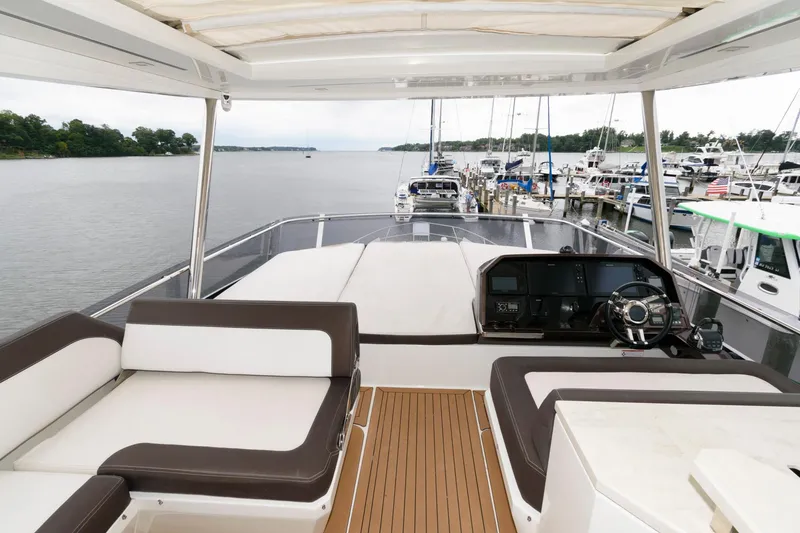 Slide: The Image of Spacious deck seating on 2018 Galeon 640 Fly yacht, featuring elegant wood flooring. - 24