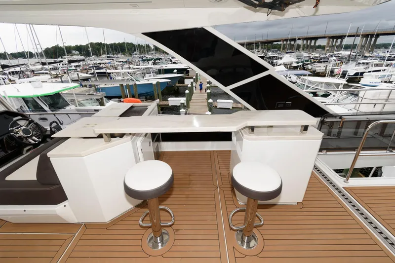 Slide: The Image of 2018 Galeon 640 Fly yacht with radar domes, docked in a marina. - 32