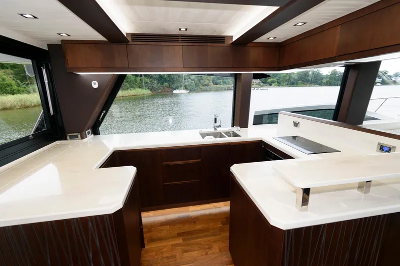 Slide: The Image of Galeon 640 Fly 2018 yacht with spacious deck, docked by a serene waterfront. - 42
