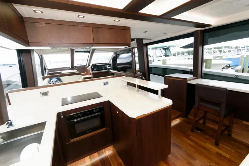 Slide: The Image of Galeon 640 Fly 2018 yacht with sun loungers in a marina setting. - 43