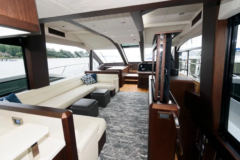 Slide: The Image of Inflatable boat on Galeon 640 Fly yacht, 2018 model, docked by a serene riverbank. - 44