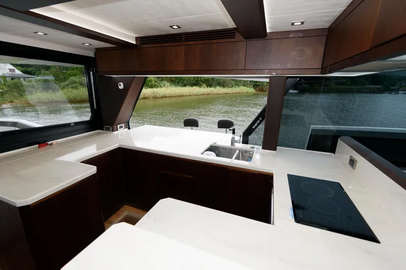 Slide: The Image of Luxurious interior of 2018 Galeon 640 Fly yacht with modern kitchen and seating area. - 47