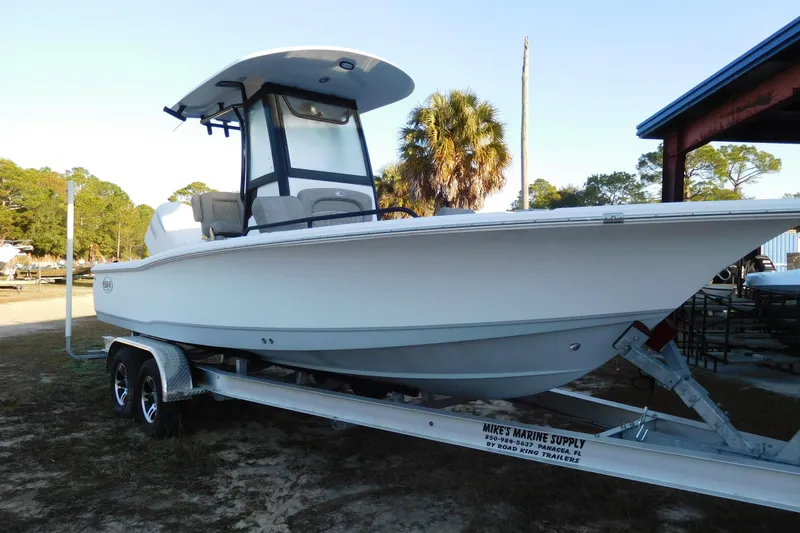 Slide: The Image of 2026 Sea Hunt BX 25 FS boat on trailer, parked outdoors near trees. - 3