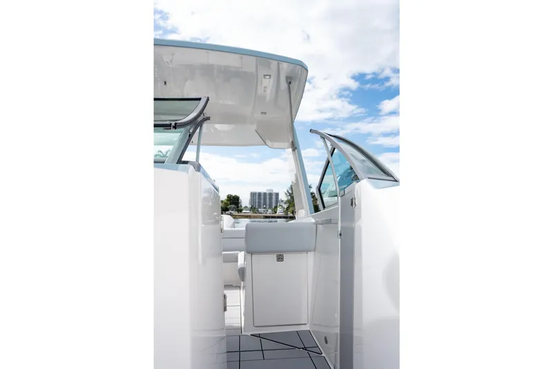 Slide: The Image of 2022 Aviara AV32 OB boat interior with open door, showcasing sleek design and clear sky. - 12