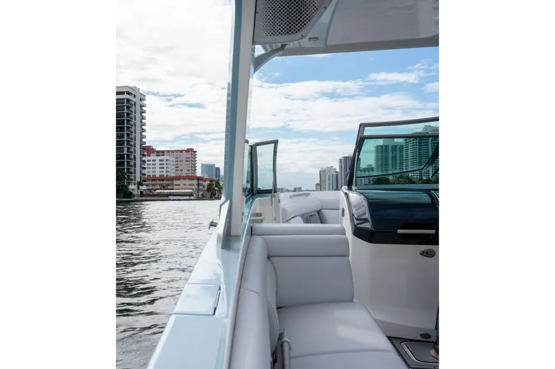 Slide: The Image of 2022 Aviara AV32 OB boat cruising near city skyline, featuring luxurious seating and modern design. - 16