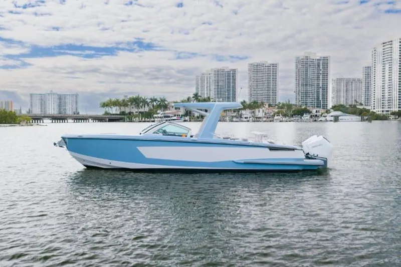 Slide: The Image of 2022 Aviara AV32 OB boat on water with city skyline background. - 2