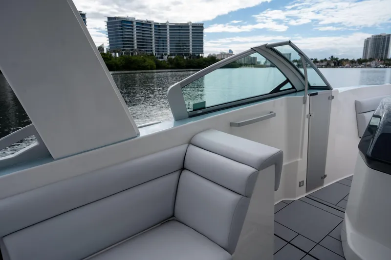 Slide: The Image of 2022 Aviara AV32 OB boat interior with modern seating and waterfront view. - 20