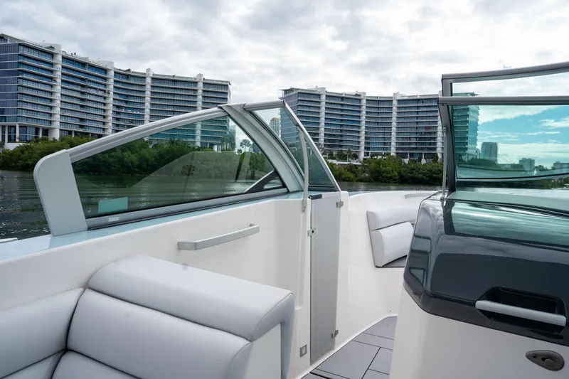 Slide: The Image of 2022 Aviara AV32 OB boat interior with modern design, cityscape in background. - 22