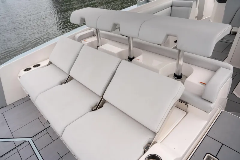 Slide: The Image of 2022 Aviara AV32 OB boat with luxurious white seating and cup holders. - 24