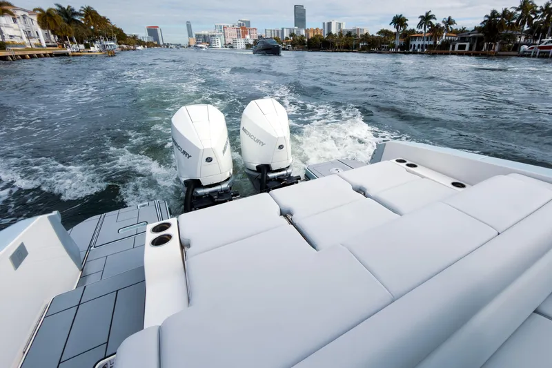 Slide: The Image of 2022 Aviara AV32 OB boat with dual Mercury outboard engines cruising on a scenic waterway. - 27