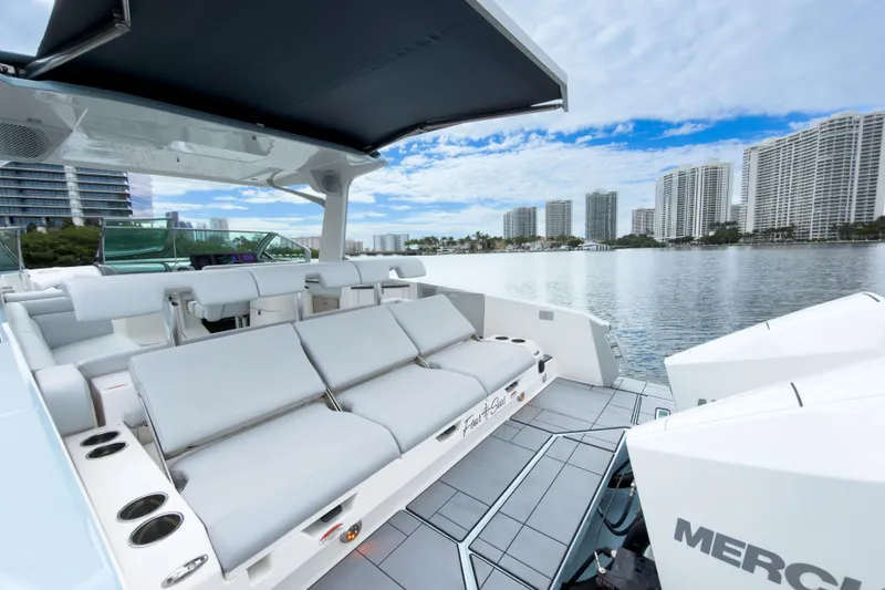 Slide: The Image of 2022 Aviara AV32 OB luxury boat with spacious seating, docked near waterfront cityscape. - 29