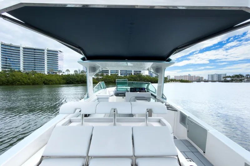 Slide: The Image of 2022 Aviara AV32 OB boat with luxurious seating, cruising on a scenic waterway. - 30