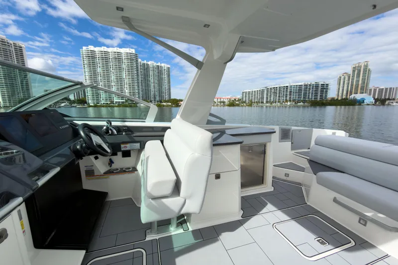 Slide: The Image of 2022 Aviara AV32 OB boat interior with modern seating and cityscape view. - 31