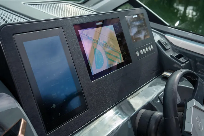 Slide: The Image of Dashboard of 2022 Aviara AV32 OB boat with navigation screens and controls. - 34
