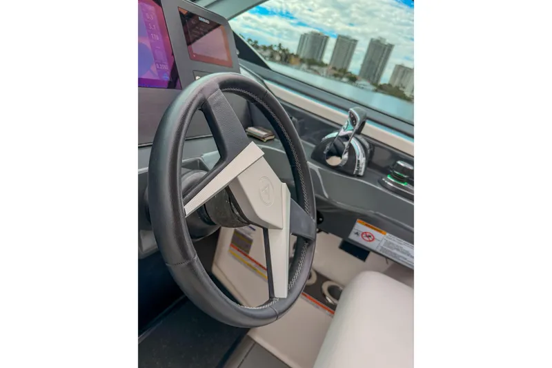 Slide: The Image of Steering wheel of 2022 Aviara AV32 OB boat with modern dashboard controls. - 35