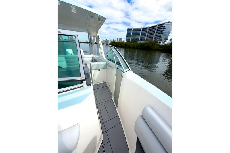 Slide: The Image of 2022 Aviara AV32 OB boat with sleek design, docked near modern buildings. - 38
