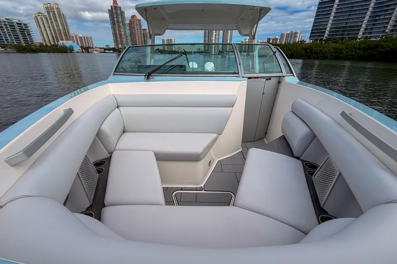 Slide: The Image of 2022 Aviara AV32 OB boat interior with white seating, city skyline in background. - 39