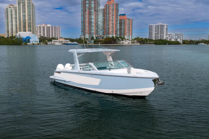 Slide: The Image of 2022 Aviara AV32 OB boat on water with city skyline background. - 6