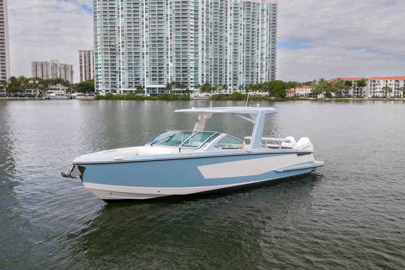 Slide: The Image of 2022 Aviara AV32 OB boat on water with cityscape background. - 7