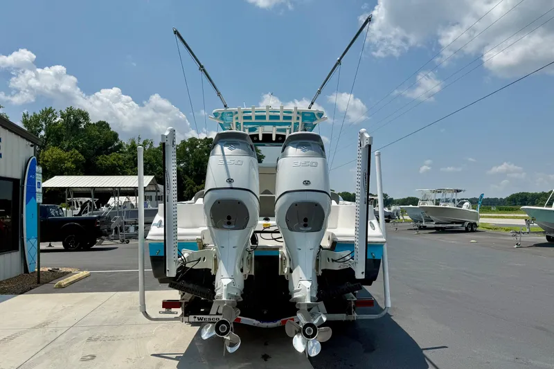 Slide: The Image of 2025 Key West 291 FS boat on trailer, vibrant blue hull, parked outdoors. - 1