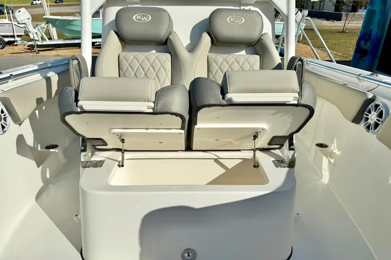 Slide: The Image of 2025 Key West 291 FS boat anchor compartment with open hatch, showcasing storage and winch. - 23