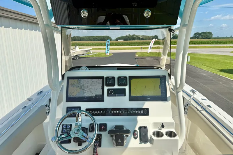 Slide: The Image of 2025 Key West 291 FS boat interior with rod holders and modern dashboard. - 32