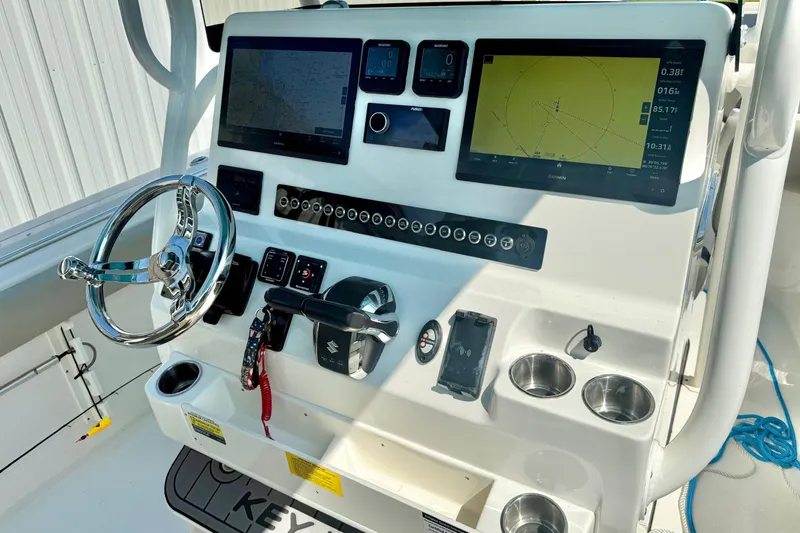 Slide: The Image of 2025 Key West 291 FS boat interior with luxurious seating and steering wheel. - 34