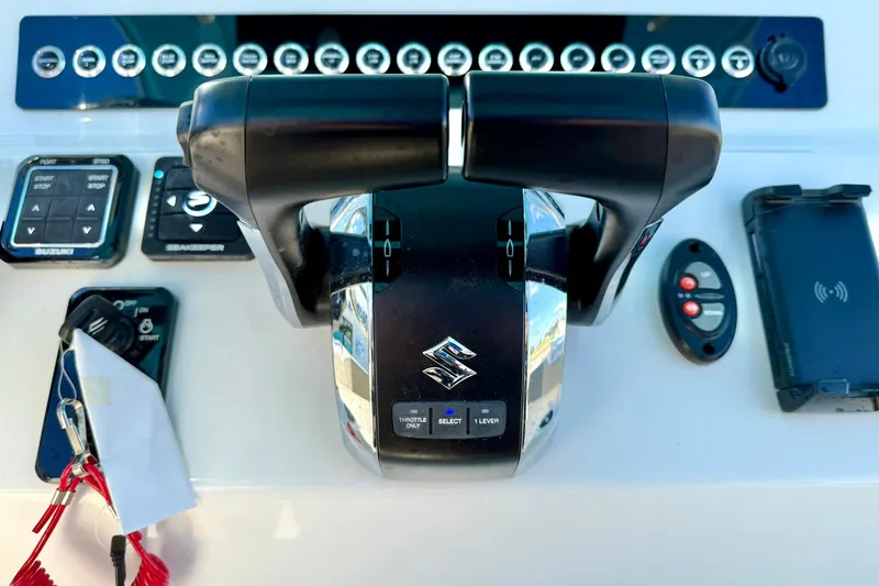 Slide: The Image of 2025 Key West 291 FS boat dashboard with navigation screens and steering wheel. - 36
