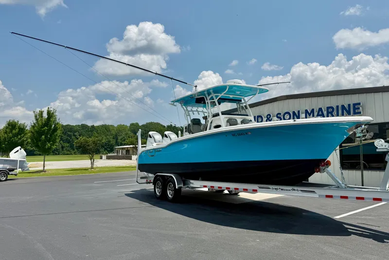 Slide: The Image of 2025 Key West 291 FS boat with fishing tackle storage under a clear blue sky. - 4