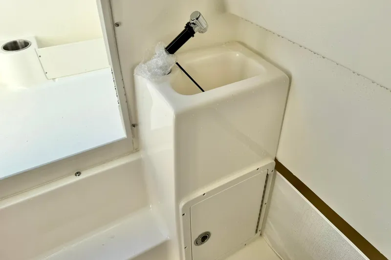 Slide: The Image of 2025 Key West 291 FS boat console with electronic controls and storage compartments. - 45