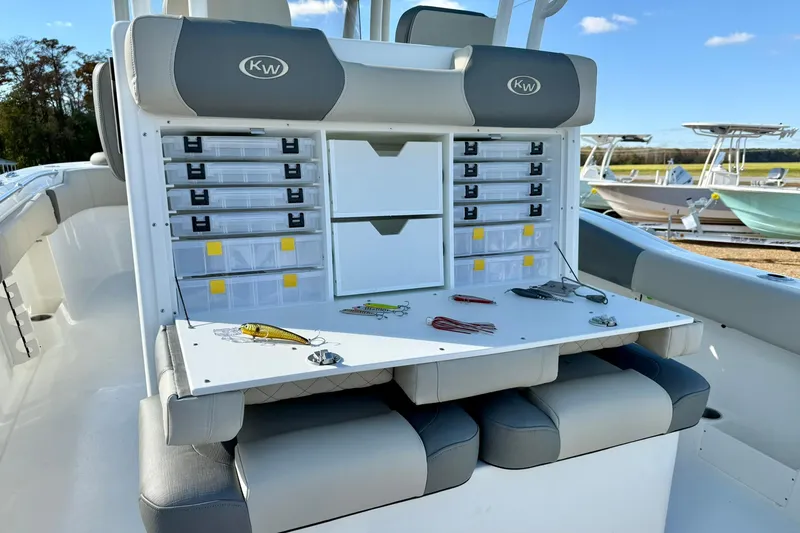 Slide: The Image of 2025 Key West 291 FS boat interior with seating and helm, displayed outdoors. - 52