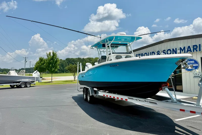 Slide: The Image of 2025 Key West 291 FS boat on trailer at dealership, clear sky background. - 6