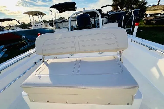 Slide: The Image of 2025 Boston Whaler 190 Montauk boat interior with cushioned seating and helm. - 13
